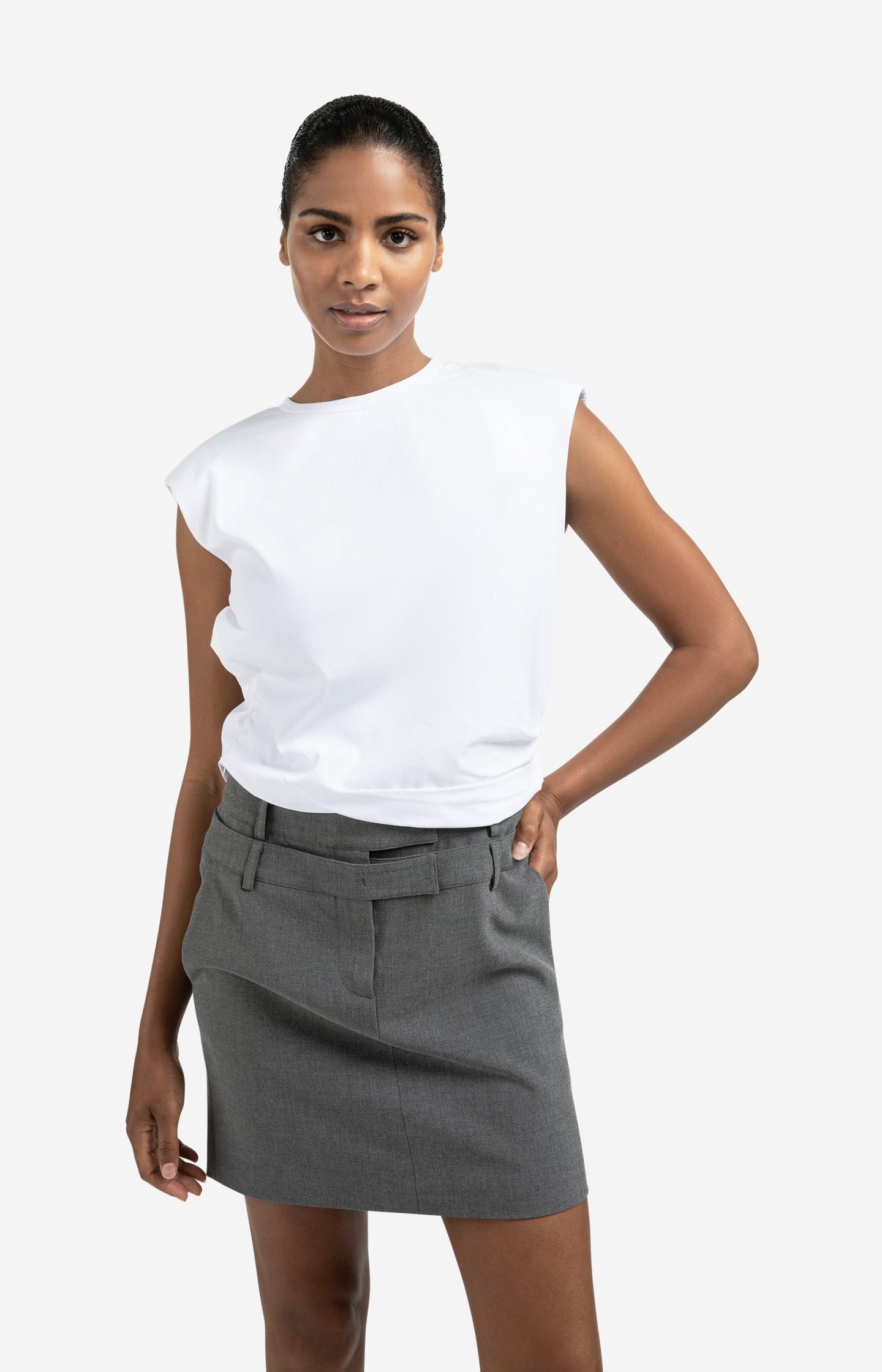 Sleeveless top with shoulder pads and pleat detail