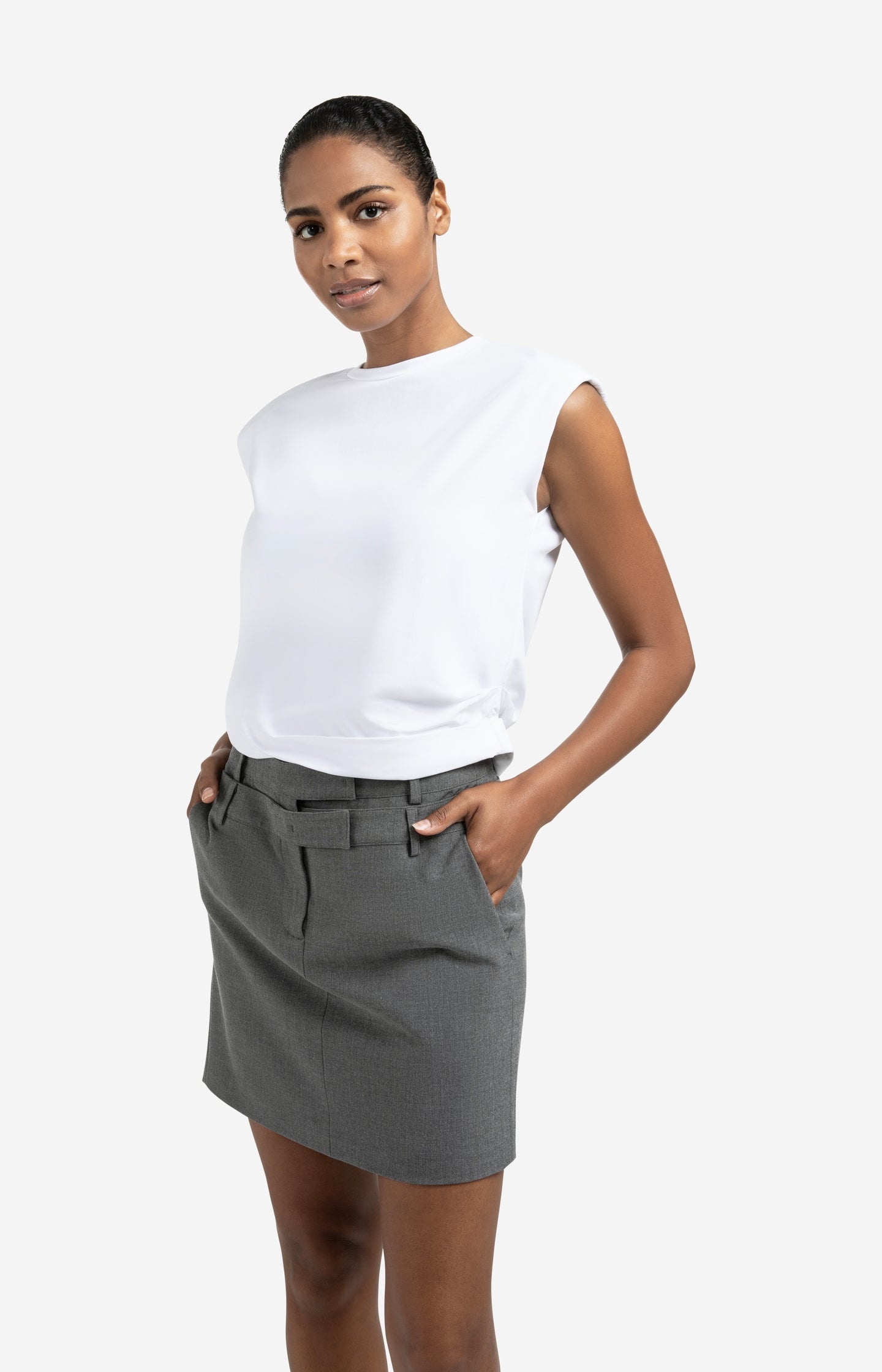 Sleeveless top with shoulder pads and pleat detail