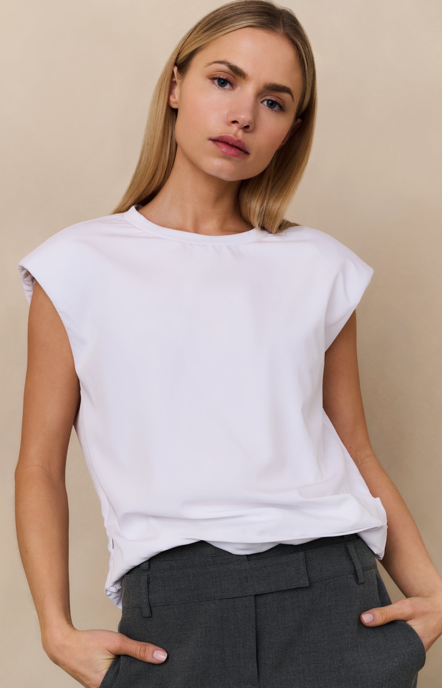 Sleeveless top with shoulder pads and pleat detail